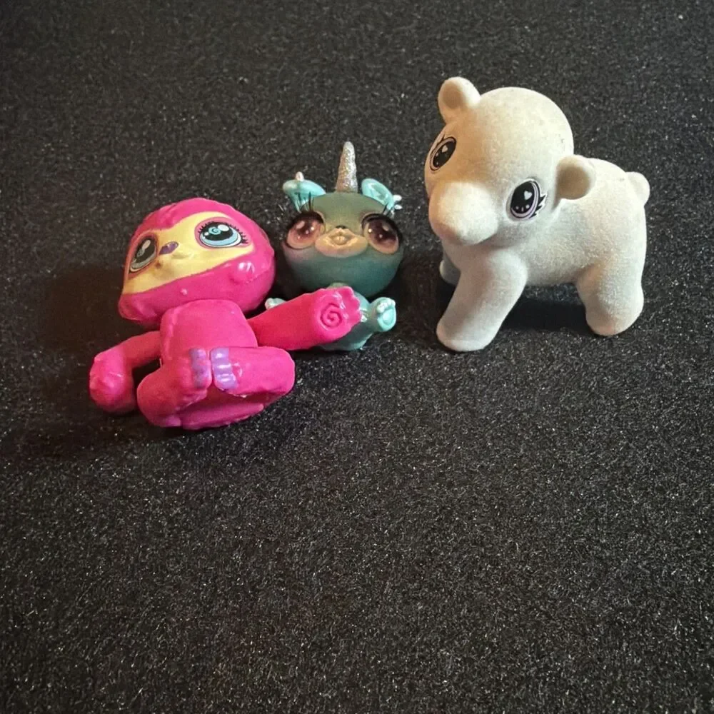 three small collectible toy figurines: Baby Crystals, Bounce Scribble Scrubbie k
